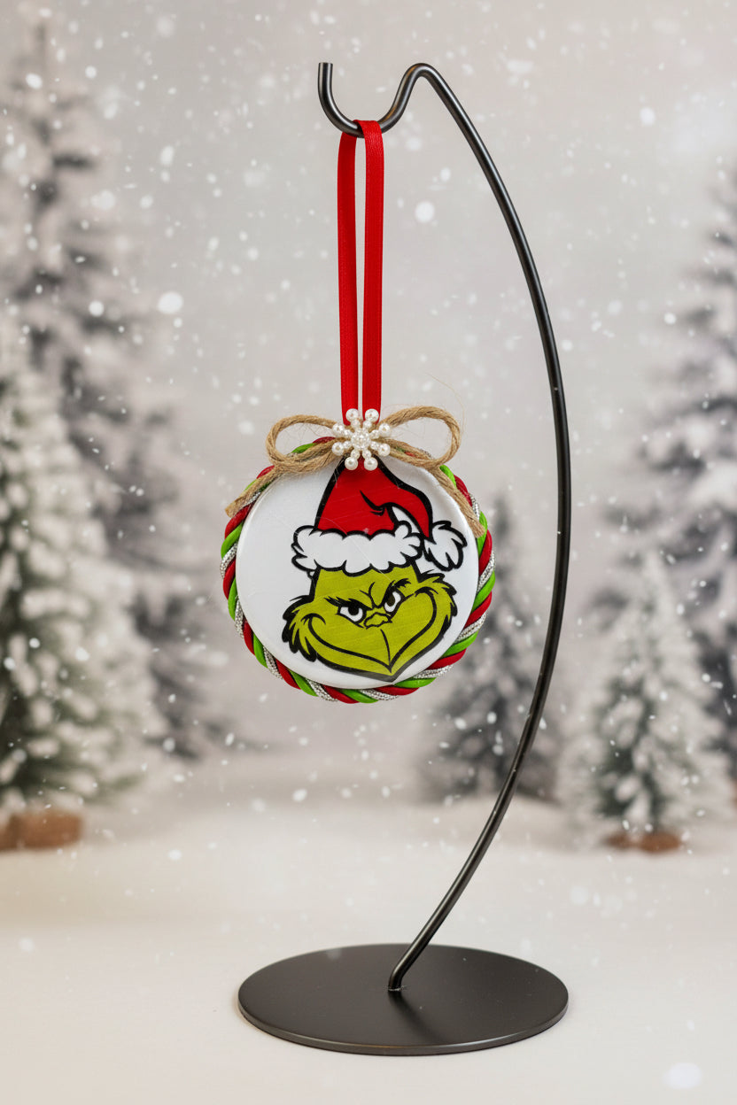 Christmas ornament with Grinch face design on a white background