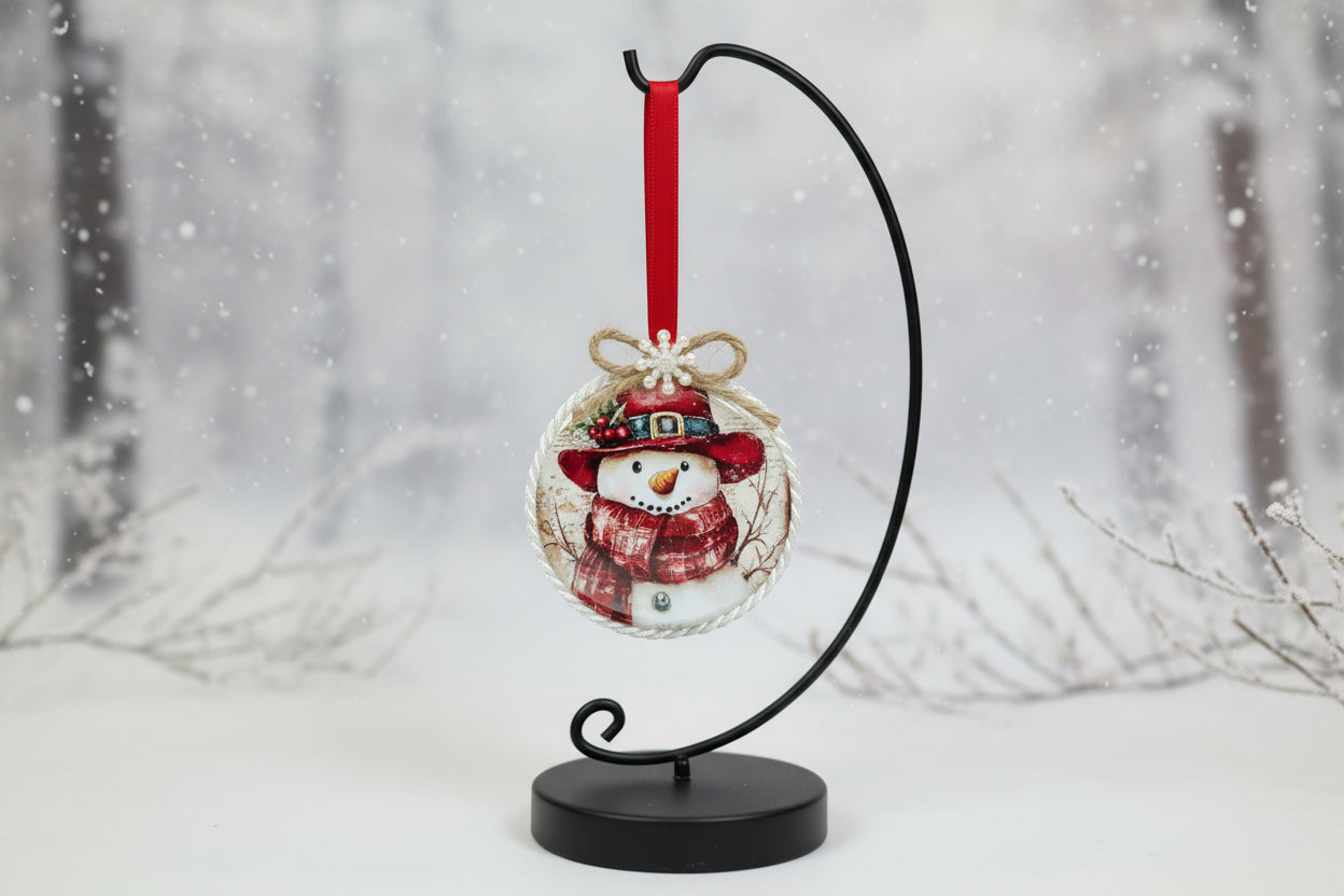 Decorative snowman ornament with a red hat and scarf on a white background