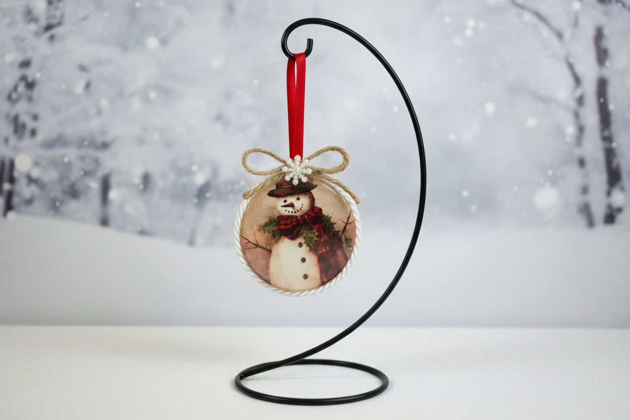 Decorative ornament with snowmen and a bow on a beige background