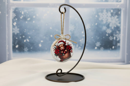 Christmas-themed ornament with a cow in a Santa hat and poinsettias on a white background