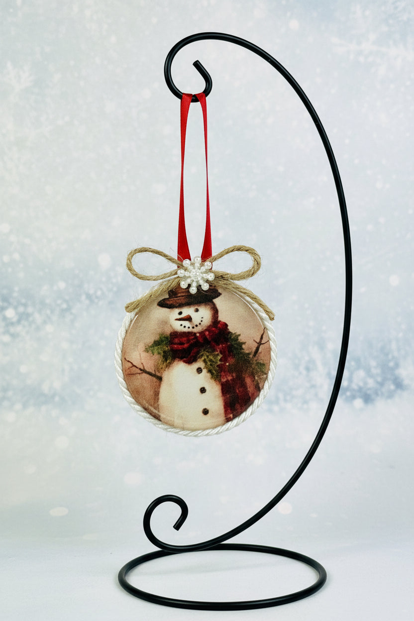 Decorative ornament with snowmen and a bow on a beige background